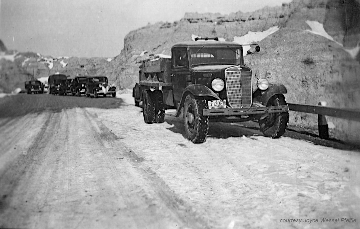 trucks along a road in the Badlands