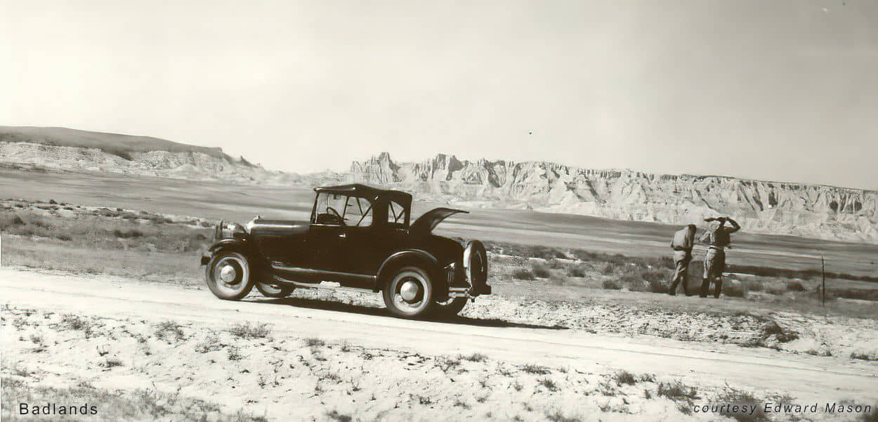 Automoble and men in the Badlands of South Dakota
