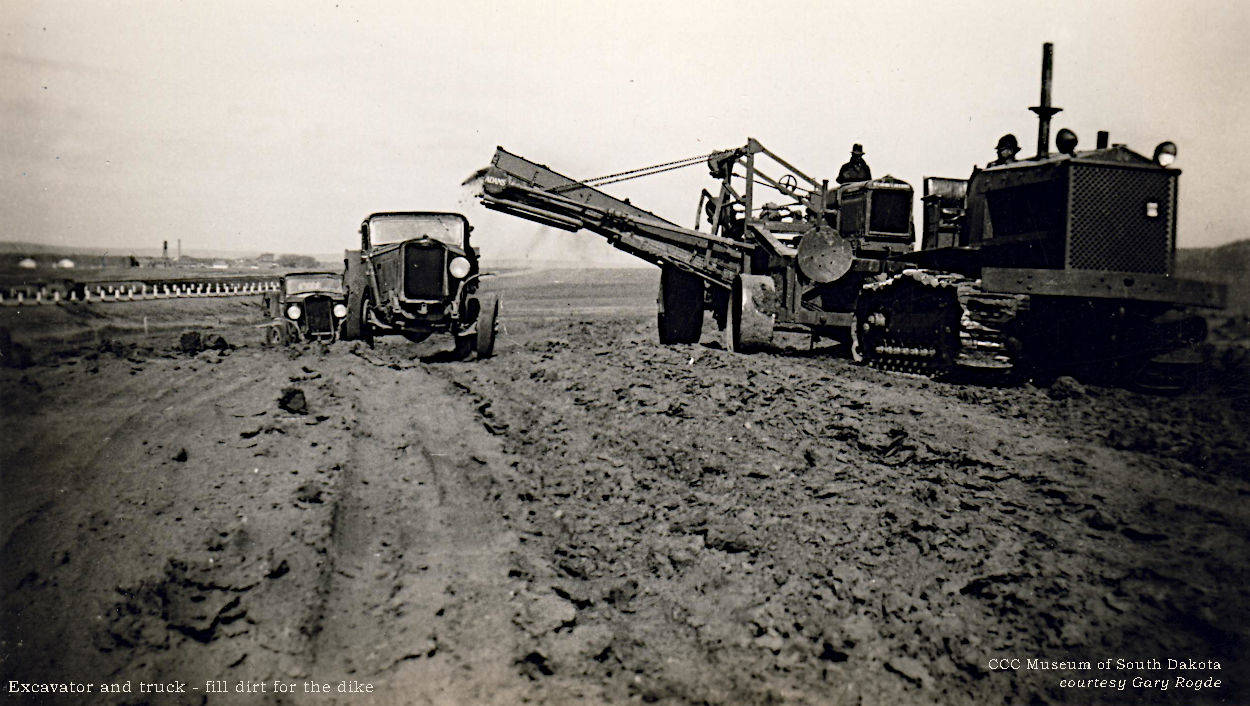 Excavator and truck - fill dirt for dike